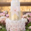 کیک خوشگل جشن بیبی شاور دخترانه تزئین شده با گل و پاپیون و کفش نوزادی