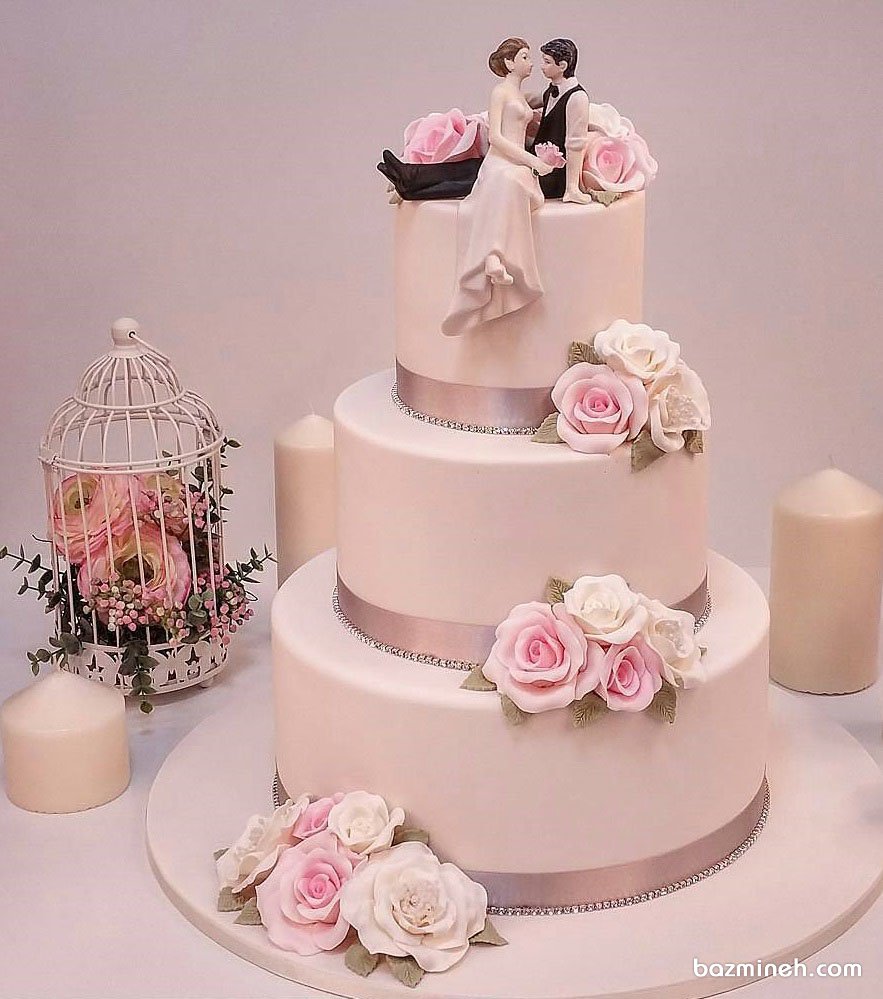 کیک چند طبقه جشن نامزدی یا سالگرد ازدواج با سبک وینتج تزیین شده با نماد عروس و داماد و گل های خمیر فوندانت