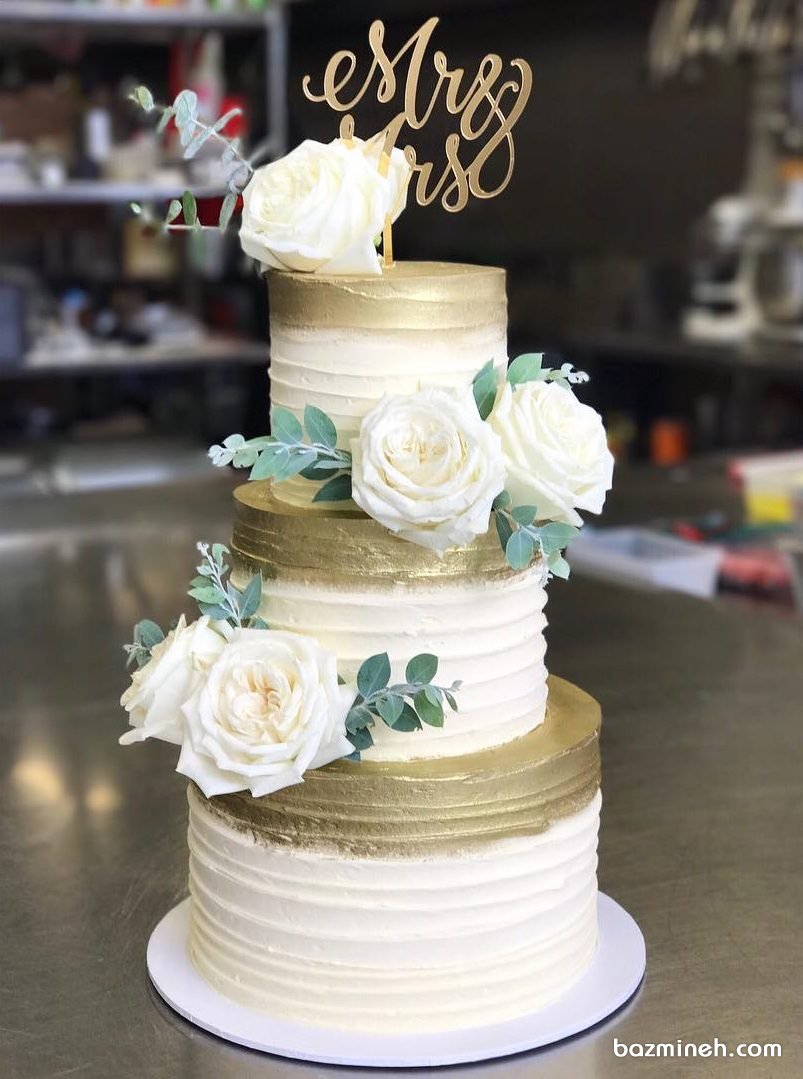 کیک سه طبقه جشن نامزدی یا عروسی با تم سفید طلایی تزیین شده با گل های رز طبیعی