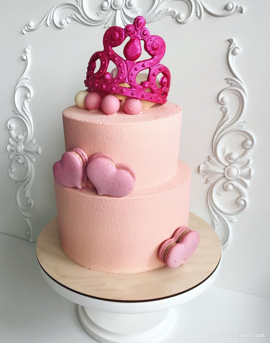کیک دو طبقه جشن تولد دخترونه با تم ملکه صورتی تزیین شده با ماکارون های قلبی